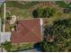 An aerial view of a single-story home featuring a well-manicured lawn and mature landscaping at 617 Glastonbury Ct, Spring Hill, FL 34609