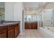A spacious bathroom boasts double sinks, a soaking tub, and glass shower at 617 Glastonbury Ct, Spring Hill, FL 34609