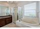 The bathroom features an oval soaking tub with a glass shower at 617 Glastonbury Ct, Spring Hill, FL 34609