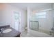 The bright bathroom includes a shower, a vanity with sink, and a toilet at 617 Glastonbury Ct, Spring Hill, FL 34609