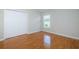 This empty bedroom has light-colored laminate floors and a double closet at 617 Glastonbury Ct, Spring Hill, FL 34609