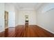 An empty bedroom with wood floors features an attached bathroom at 617 Glastonbury Ct, Spring Hill, FL 34609