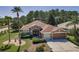 Charming single-story home featuring a well-manicured lawn, mature landscaping, and a two-car garage at 617 Glastonbury Ct, Spring Hill, FL 34609