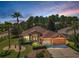 Charming single-story home featuring a well-manicured lawn, mature landscaping, and a two-car garage at 617 Glastonbury Ct, Spring Hill, FL 34609