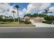 Charming home featuring a manicured lawn, mature palm trees, and an attached two-car garage at 617 Glastonbury Ct, Spring Hill, FL 34609