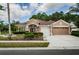Stunning single-story home featuring a manicured lawn, neutral stucco, and an attached two-car garage at 617 Glastonbury Ct, Spring Hill, FL 34609