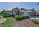Beautiful single-story home with meticulously maintained landscaping and an attached two-car garage at 617 Glastonbury Ct, Spring Hill, FL 34609