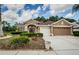 Beautiful single-story home with a well-manicured front lawn and attached two-car garage at 617 Glastonbury Ct, Spring Hill, FL 34609