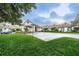 Welcoming exterior view with covered entrance and well-manicured landscaping at 617 Glastonbury Ct, Spring Hill, FL 34609