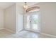 Welcoming foyer with double glass doors, tile flooring, and decorative light fixtures at 617 Glastonbury Ct, Spring Hill, FL 34609