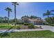 Well-manicured front lawn featuring mature landscaping and a single-story home at 617 Glastonbury Ct, Spring Hill, FL 34609