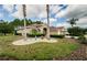 Beautiful front yard with mature palm trees, landscape beds, and manicured lawn at 617 Glastonbury Ct, Spring Hill, FL 34609