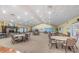 Spacious hall with a fireplace, tables and chairs at 617 Glastonbury Ct, Spring Hill, FL 34609