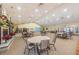 Large hall with tables, chairs, and fireplace with festive holiday decorations at 617 Glastonbury Ct, Spring Hill, FL 34609