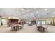 Spacious hall with tables, chairs, stage, and festive holiday decor at 617 Glastonbury Ct, Spring Hill, FL 34609