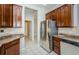 Kitchen featuring stainless steel appliances, granite countertops, and wooden cabinets at 617 Glastonbury Ct, Spring Hill, FL 34609