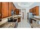 Kitchen showcasing granite countertops, stainless steel appliances, and wooden cabinets at 617 Glastonbury Ct, Spring Hill, FL 34609