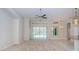 Spacious living room with a ceiling fan and sliding glass doors at 617 Glastonbury Ct, Spring Hill, FL 34609