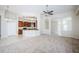 Open-concept living room flows into a kitchen with dark wood cabinetry and stainless appliances at 617 Glastonbury Ct, Spring Hill, FL 34609