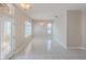 Bright and airy living room with neutral walls, tile floors, and a decorative light fixture at 617 Glastonbury Ct, Spring Hill, FL 34609