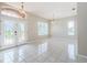 Bright and airy living room with tile floors, large windows, and decorative light fixtures at 617 Glastonbury Ct, Spring Hill, FL 34609