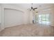 Bright living room with a ceiling fan and sliding glass doors at 617 Glastonbury Ct, Spring Hill, FL 34609