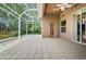 Tiled patio with screen enclosure and view of backyard at 617 Glastonbury Ct, Spring Hill, FL 34609
