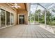 Spacious screened patio with tiled floor and ceiling fan at 617 Glastonbury Ct, Spring Hill, FL 34609