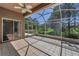 Screened lanai with tile flooring offers a view of the spacious green backyard at 617 Glastonbury Ct, Spring Hill, FL 34609