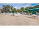 Outdoor seating and lounging area with green umbrellas overlooking the community pool at 617 Glastonbury Ct, Spring Hill, FL 34609