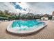 Resort-style pool with lush landscaping and ample lounging space at 617 Glastonbury Ct, Spring Hill, FL 34609