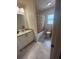 Bathroom featuring tiled flooring, vanity, bathtub, and a floral shower curtain at 641 N Garden Ave, Clearwater, FL 33755