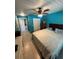 Bedroom with blue walls, a ceiling fan, and a bed with beige and blue linens at 641 N Garden Ave, Clearwater, FL 33755