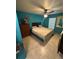 Bedroom featuring tiled floor, ceiling fan, window, and a bed with blue accents at 641 N Garden Ave, Clearwater, FL 33755