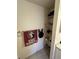 Linen closet with towels, shelves and hooks, and white trim at 641 N Garden Ave, Clearwater, FL 33755