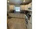 Well-lit kitchen with white appliances, tile flooring, and light countertops at 641 N Garden Ave, Clearwater, FL 33755