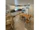 Bright kitchen featuring white cabinets, tile floors, and an adjacent dining area at 641 N Garden Ave, Clearwater, FL 33755