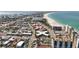 An aerial shot reveals the building's close location to the beach and surrounding buildings at 7050 Sunset Way # 22, St Pete Beach, FL 33706