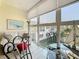 Bright enclosed balcony with outdoor seating, showcasing great views and relaxing ambiance at 7050 Sunset Way # 22, St Pete Beach, FL 33706