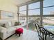 Enclosed balcony with outdoor seating, filled with natural light and showcasing peaceful views at 7050 Sunset Way # 22, St Pete Beach, FL 33706