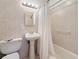 Cozy bathroom featuring cream-colored tiles, sink, toilet, shower and bathtub at 7050 Sunset Way # 22, St Pete Beach, FL 33706