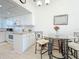 View of the dining area with seating and a view of the kitchen at 7050 Sunset Way # 22, St Pete Beach, FL 33706