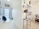 Bright entryway featuring light laminate flooring, a hall table, and a view of the kitchen at 7050 Sunset Way # 22, St Pete Beach, FL 33706