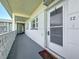 View of the outside hallway leading to the unit's entrance with a storm door at 7050 Sunset Way # 22, St Pete Beach, FL 33706