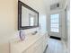 Bright hallway featuring a large mirror and a door out to the hallway at 7050 Sunset Way # 22, St Pete Beach, FL 33706