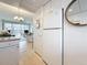 The kitchen and the living room beyond are separated by a wide opening providing an inviting atmosphere at 7050 Sunset Way # 22, St Pete Beach, FL 33706