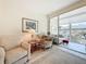Bright living room featuring large sliding glass doors and comfortable seating, filled with natural light at 7050 Sunset Way # 22, St Pete Beach, FL 33706