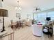 Bright living room area with seating, dining area, and large sliding glass doors to the patio at 7050 Sunset Way # 22, St Pete Beach, FL 33706