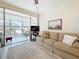 Cozy living room with a comfortable sofa and balcony access, showcasing a relaxing space at 7050 Sunset Way # 22, St Pete Beach, FL 33706