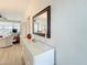 Bright hallway featuring a large mirror and a view out the window to the living room at 7050 Sunset Way # 22, St Pete Beach, FL 33706